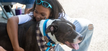 young girl holding dog