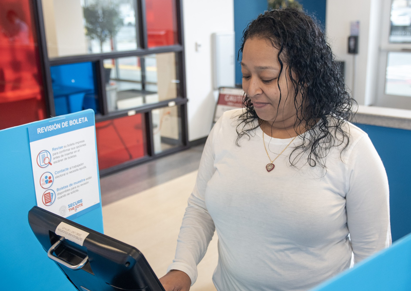 woman standing in voting booth