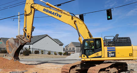 excavator moving dirt pile