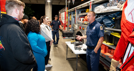 Image of a firefighter leading a small group of residents.