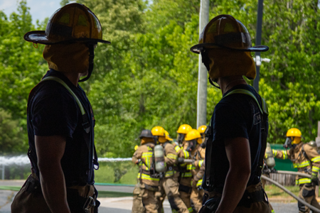 Firefighters looking on as comrades are on the move.