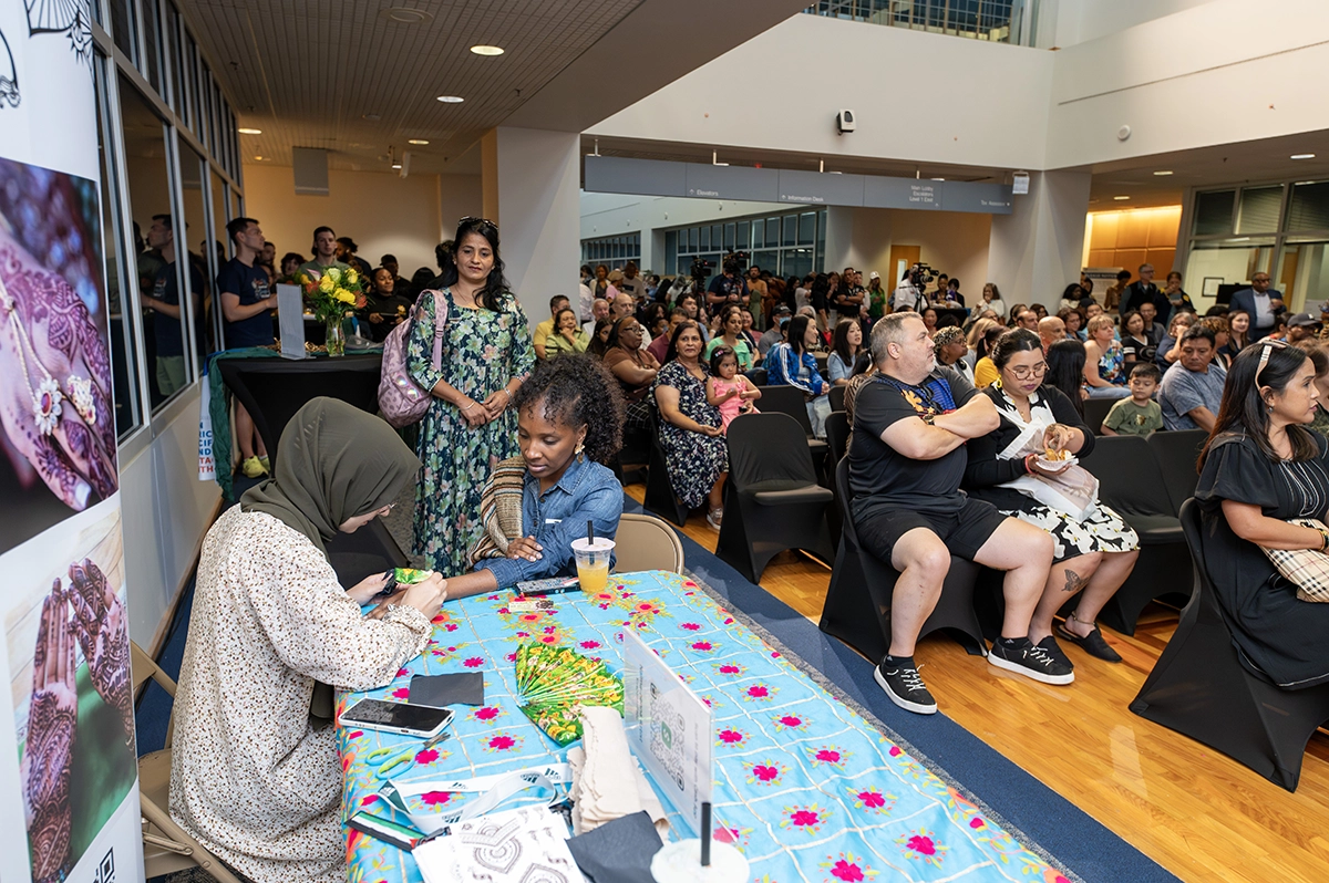 Attendee getting a henna tattoo by one of the vendors