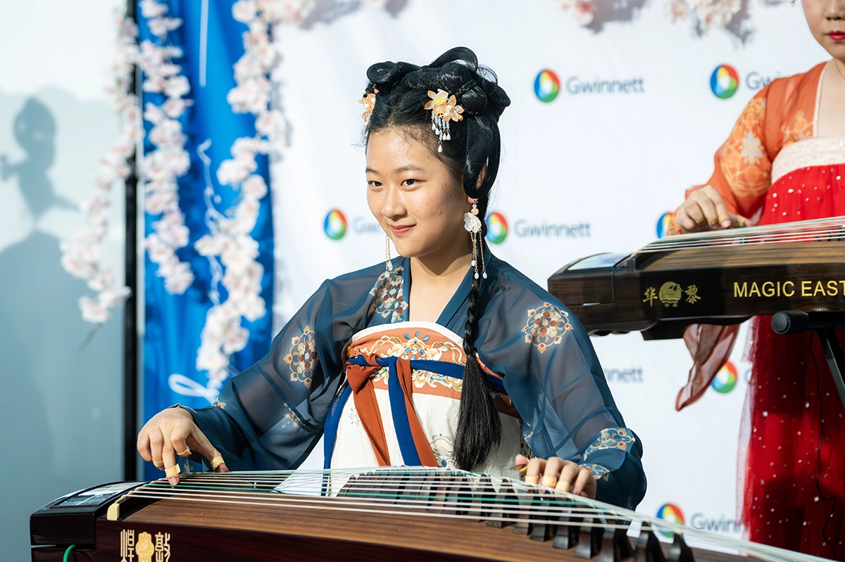 Female performer playing an instrument at the 2025 Asian American and Pacific Islander Celebration