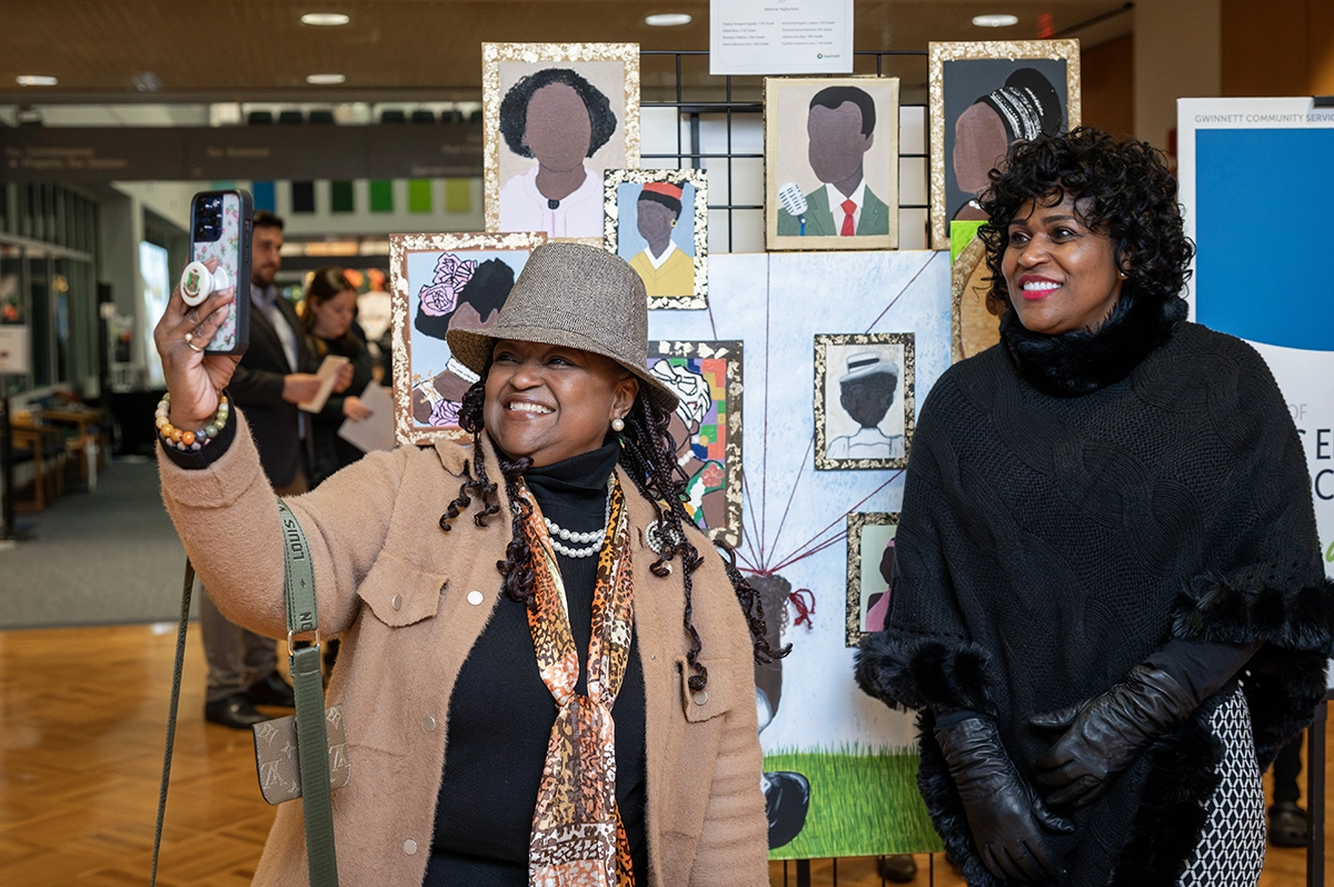 Attendees taking selfies with the display