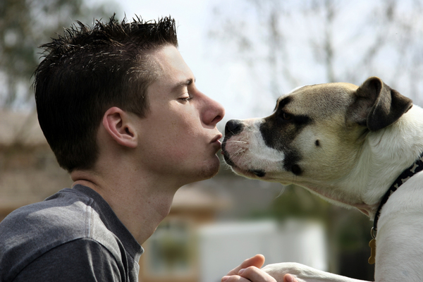 Man kissing a Dog