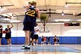 People playing basketball in an indoor gym