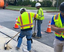 construction worker sweeping road