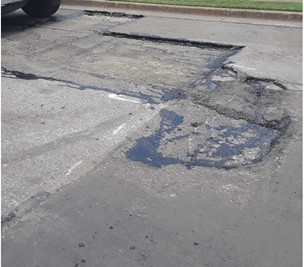 damaged asphalt showing pothole