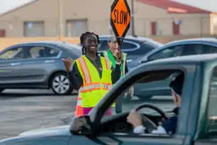 young girl directing traffic