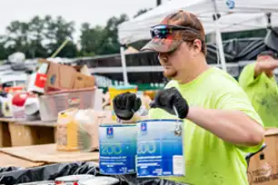 young man removing hazardous items from car